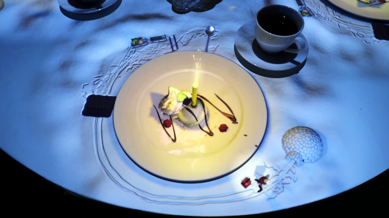 Miniature Chef projected onto table to create dessert 
