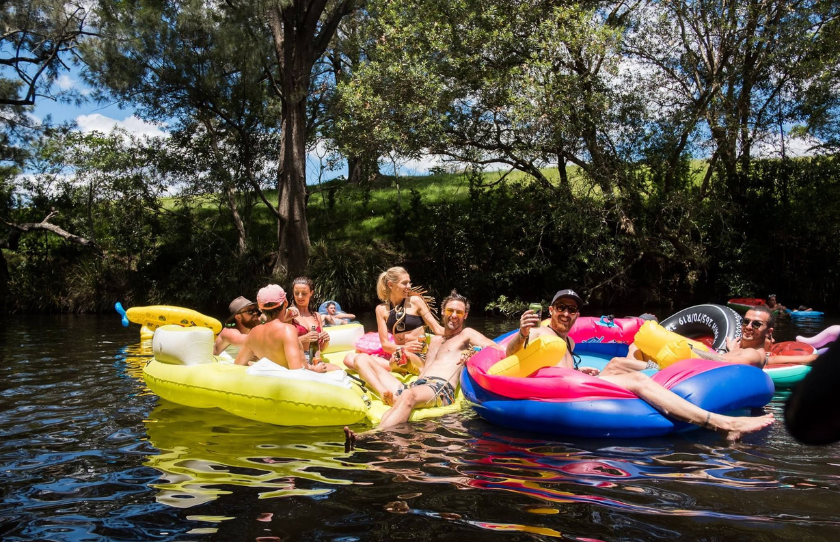 Subsonic Music Festival attendees lounging on pool floaties in Karuah River.