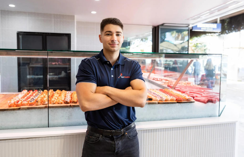 Get Sashimi owner Antonio Muollo standing proudly infront of fresh sashimi display in store.