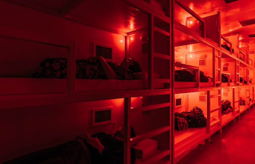 Players lying in bunkbeds for the experience of COMA at Darkfield Sydney.
