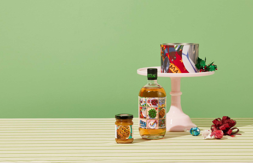 Four Pillars Christmas range for 2023 featuring small jar of ham glaze, gin bottle and pudding packaging.