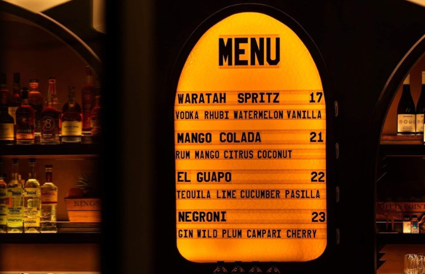 Golden lit up menu of drinks at The Waratah