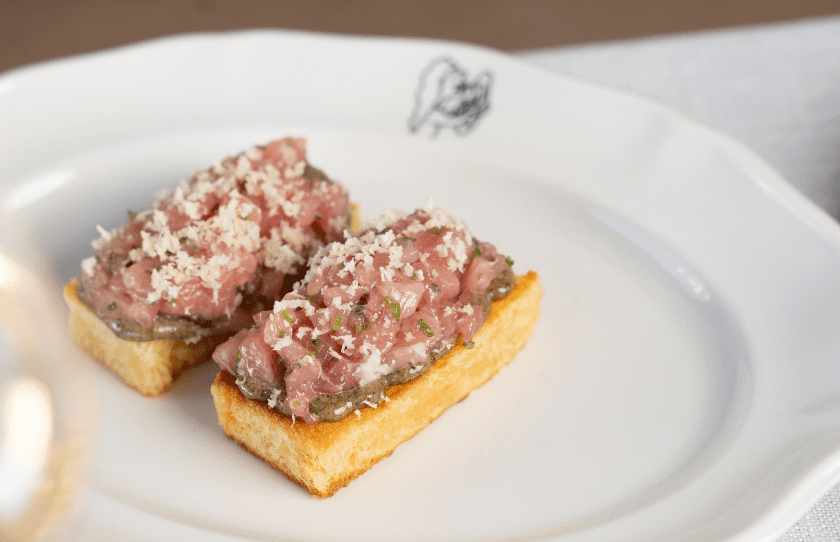 Two pieces of Tuna Toro Toast on a white plate