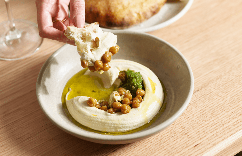 Restaurants Open on Monday Sydney - Hummus and bread being dipped into it Dining