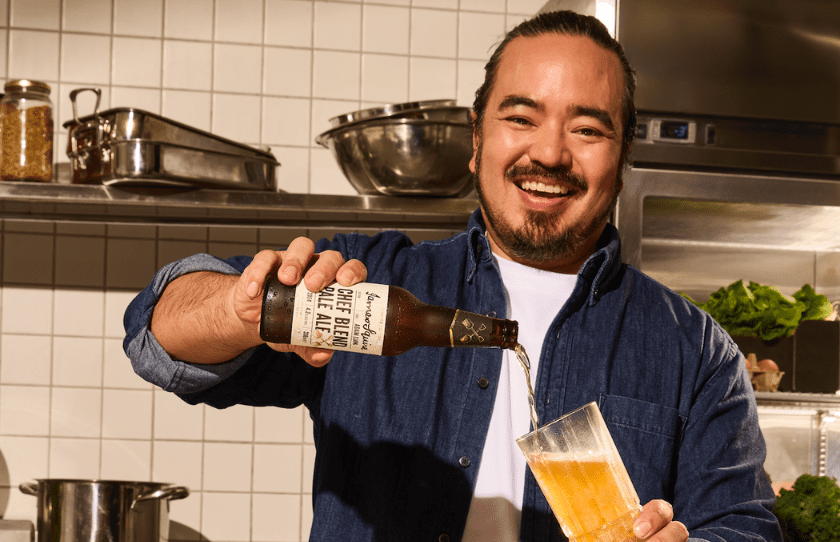 Adam Liaw pouring a beer into a glass to promote the 3-course lunch at the Squire's Landing August 