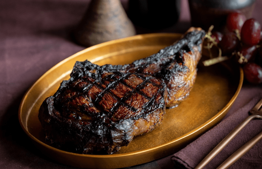 Picture of steak on a gold plate