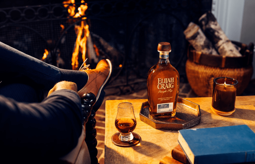 Elijah Craig Whiksy on a tray in front of the fire with two glasses