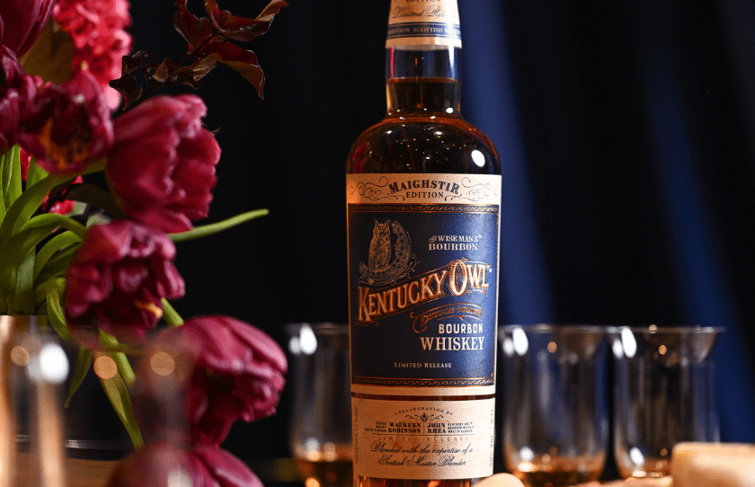 Kentucky Owl Whiskey Bourbon with flowers in the background