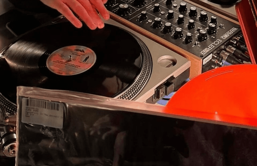 DJ Spinning a record on the decks - Best Vinyl bars in Sydney