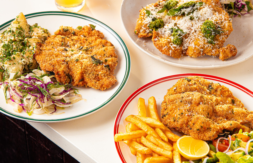 pork schnitzel with fries, salad, lemon and coleslaw at the Laundy hotel group by Jamie Gannon