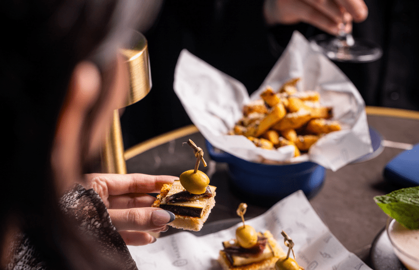 Image of elevated br snakcs like olive toast and fries at new opening Dry Martini by Grant Collins on Kensington St